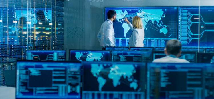 man and woman colleagues looking at digital world map in technological defence lab